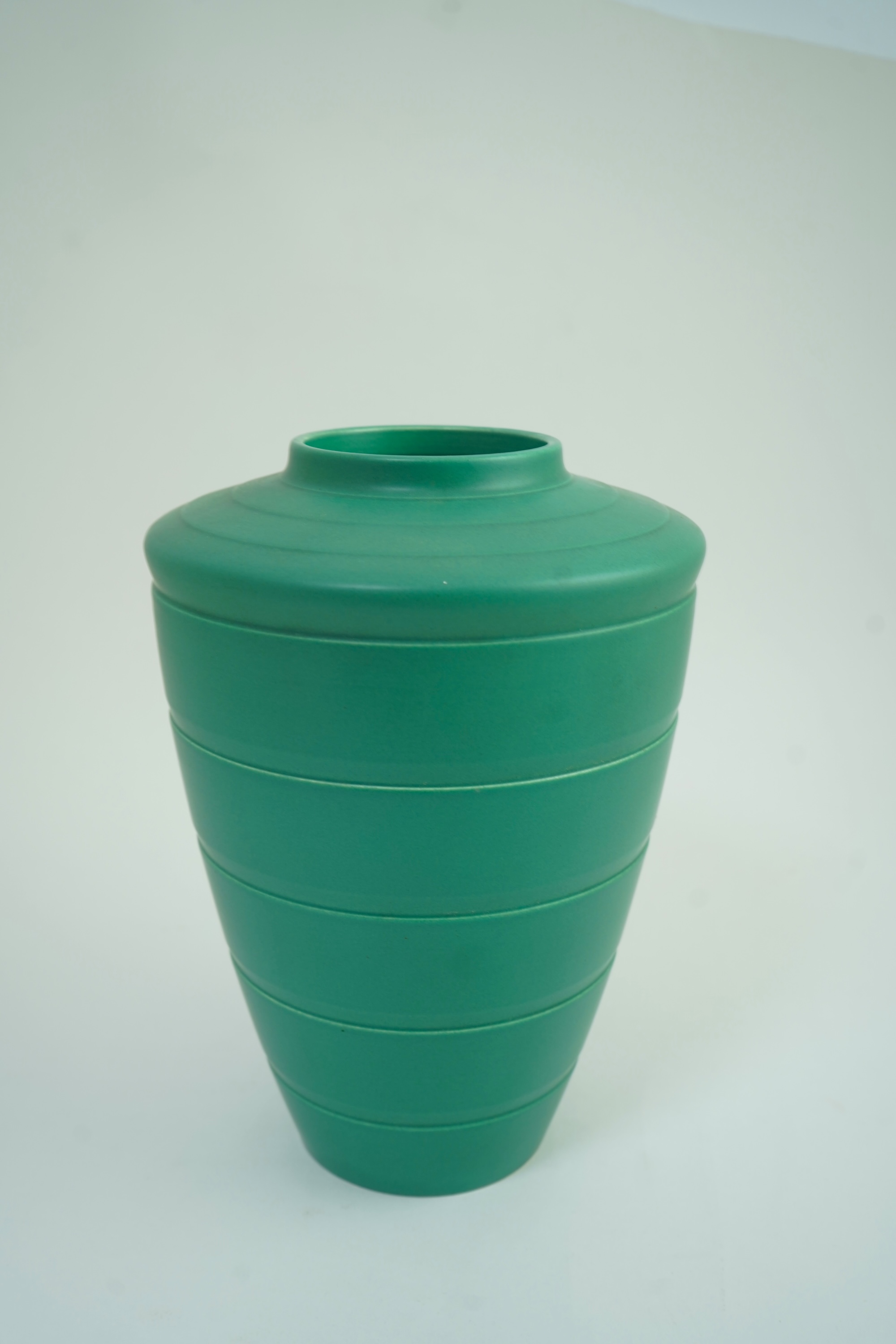 Keith Murray MC RDI FRIBA (New Zealand/British, 1892-1981) for Wedgwood: A matt green glazed tapering vase